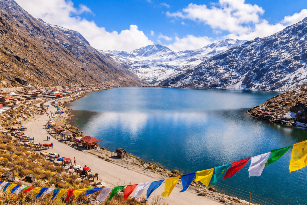 Tsomgo Lake with prayer flags and yaks