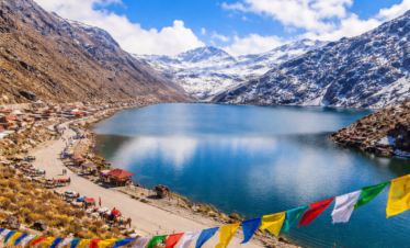 Tsomgo Lake with prayer flags and yaks
